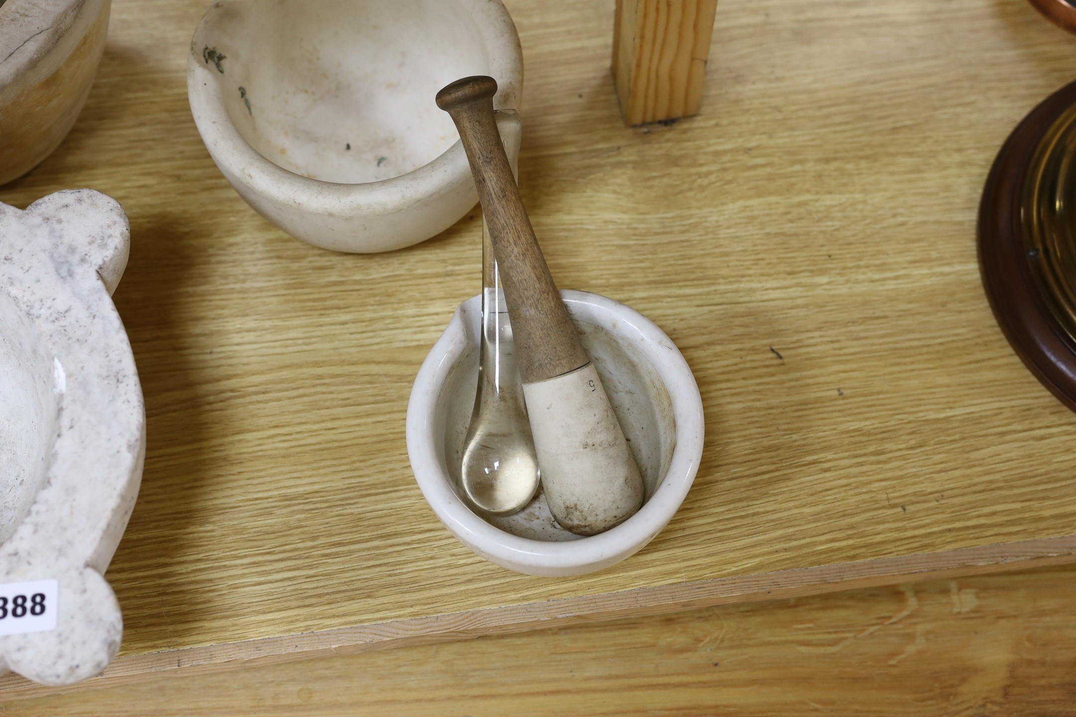 A collection of white marble and other mortars together with glass and other pestles (qty), largest 32 cms wide